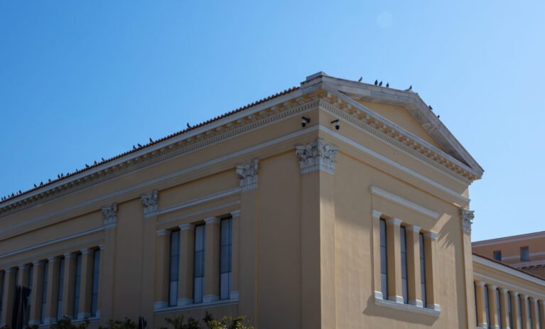 Zappeion Megaron facade, Greece national monument, Athens landmark. Classical view detai, side view Zappeion Megaron facade, Greece national monument, Athens landmark. Birds resting on Megaron tiled roof. Classical view detai, side view.
